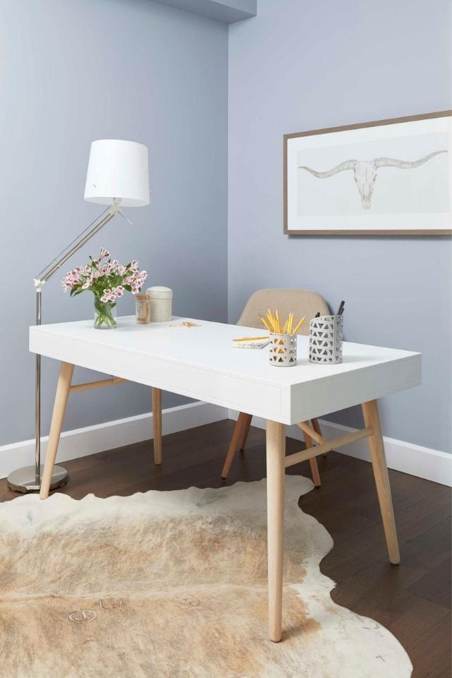 Teenager's workspace with simple white desk and elevated decor