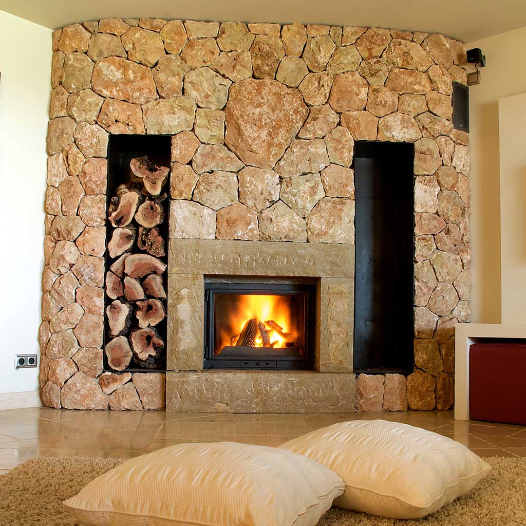 12 Cozy & Beautiful Fireplaces http://www.beautifuldesignmadesimple.com large stone fireplace with built-in wood storage warms a tile floor Photo: Gel Fireplaces