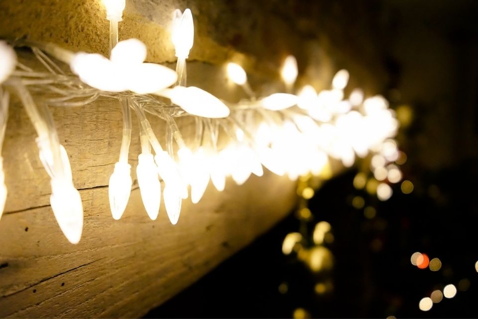 String of white Christmas lights on wood
