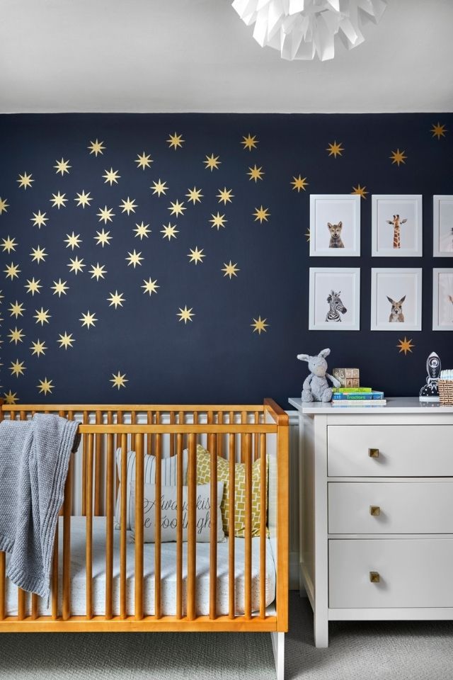 Boy's nursery room with dark walls and art